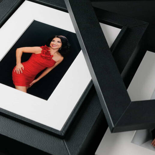 A leather-covered box filled with matted printed portraits.