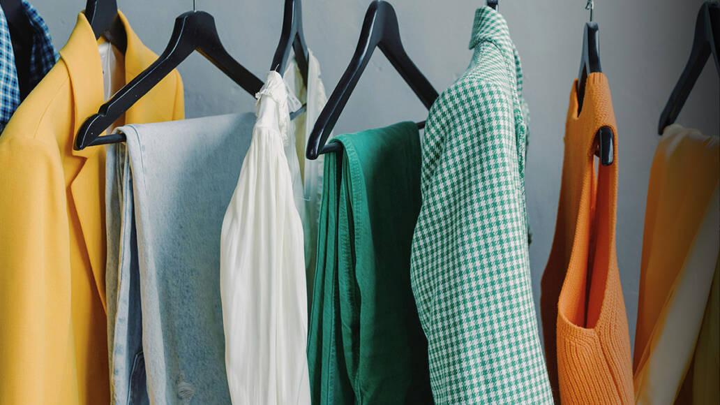 A closeup photo of clothes hanging on hangers