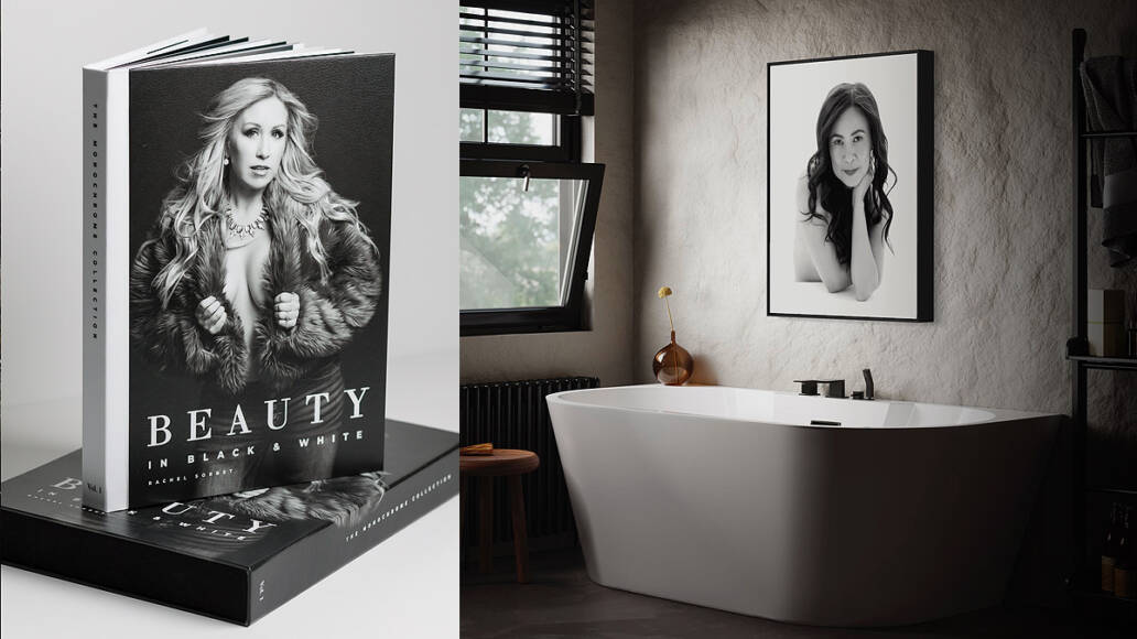 An art photo book sitting on a tabletop featuring a beautiful woman and a piece of wall art hanging on a wall over a bathtub