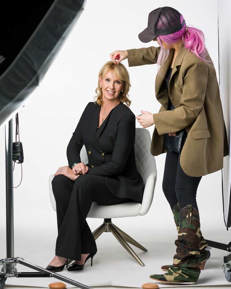 A behind the scenes look at an executive portrait being photographed in studio